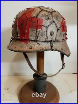 World War II German M35 Half Basket Winter Medic Camo Painted Aged Helmet