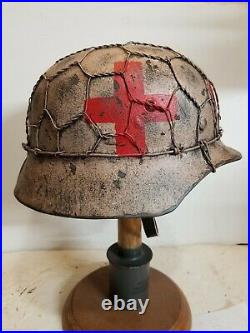 World War II German M35 Half Basket Winter Medic Camo Painted Aged Helmet